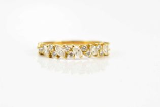 An 18ct yellow gold diamond set dress ring set with marquise and round brilliant cut diamonds,