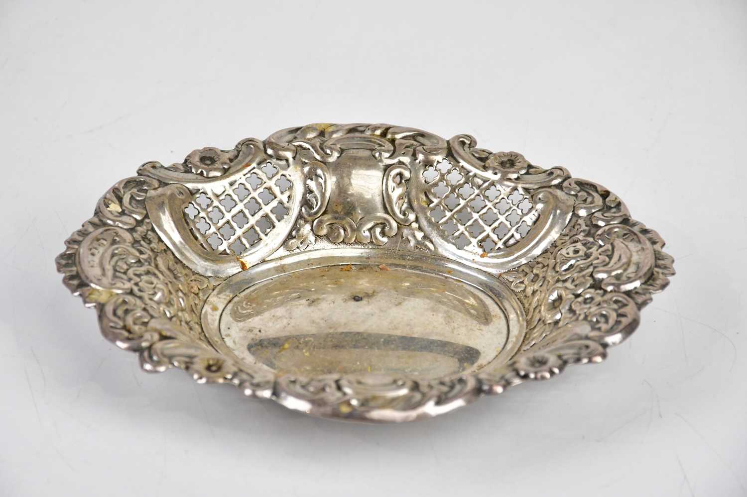 J J; a Victorian hallmarked silver bonbon dish of oval form, with pierced and repoussé decorated