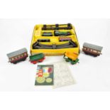 HORNBY; an O gauge clockwork train set, together with further loose clockwork carriages.