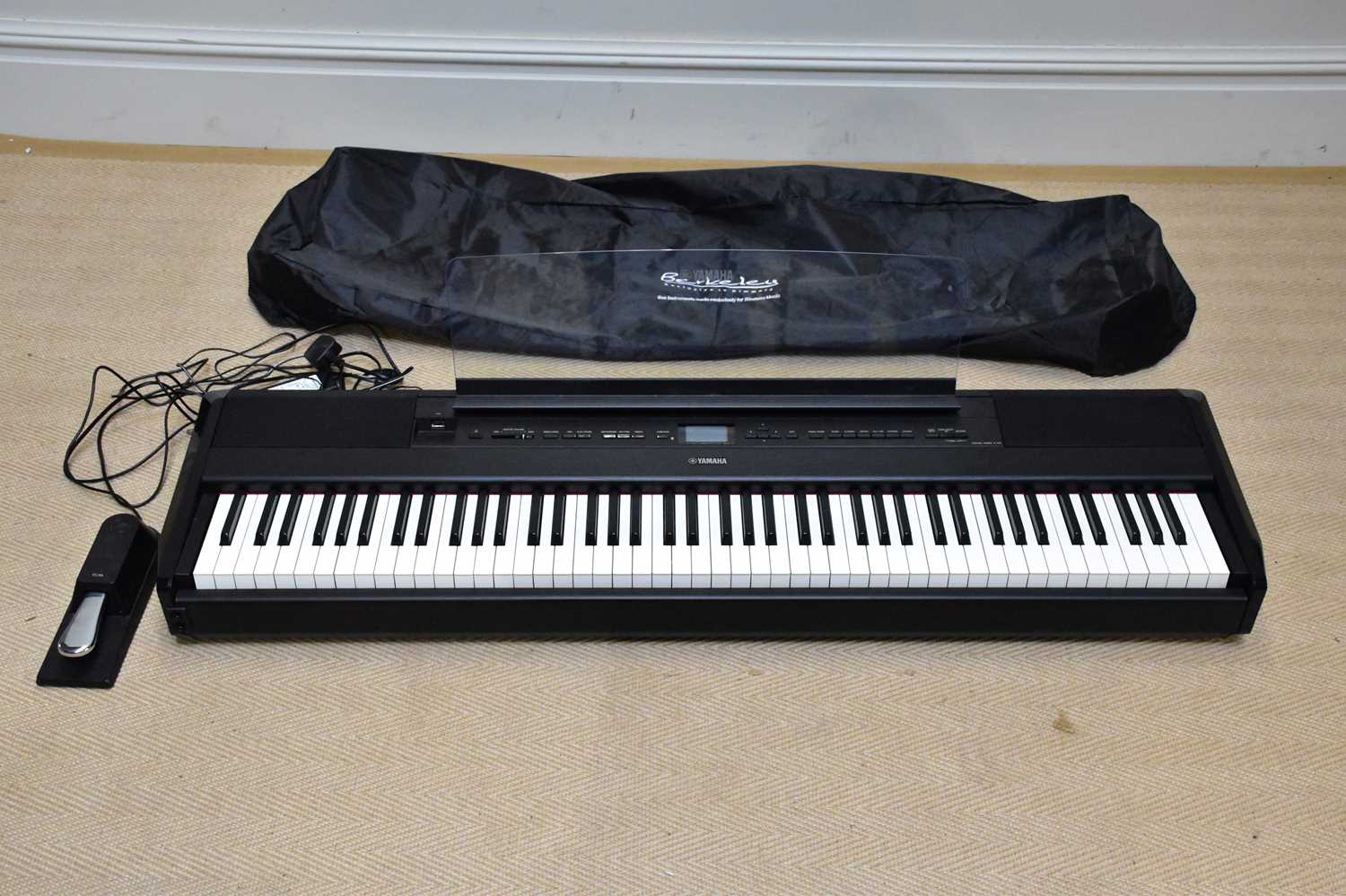 A Yamaha P-515 digital piano. Condition Report: Powers on at this time and is in good over all
