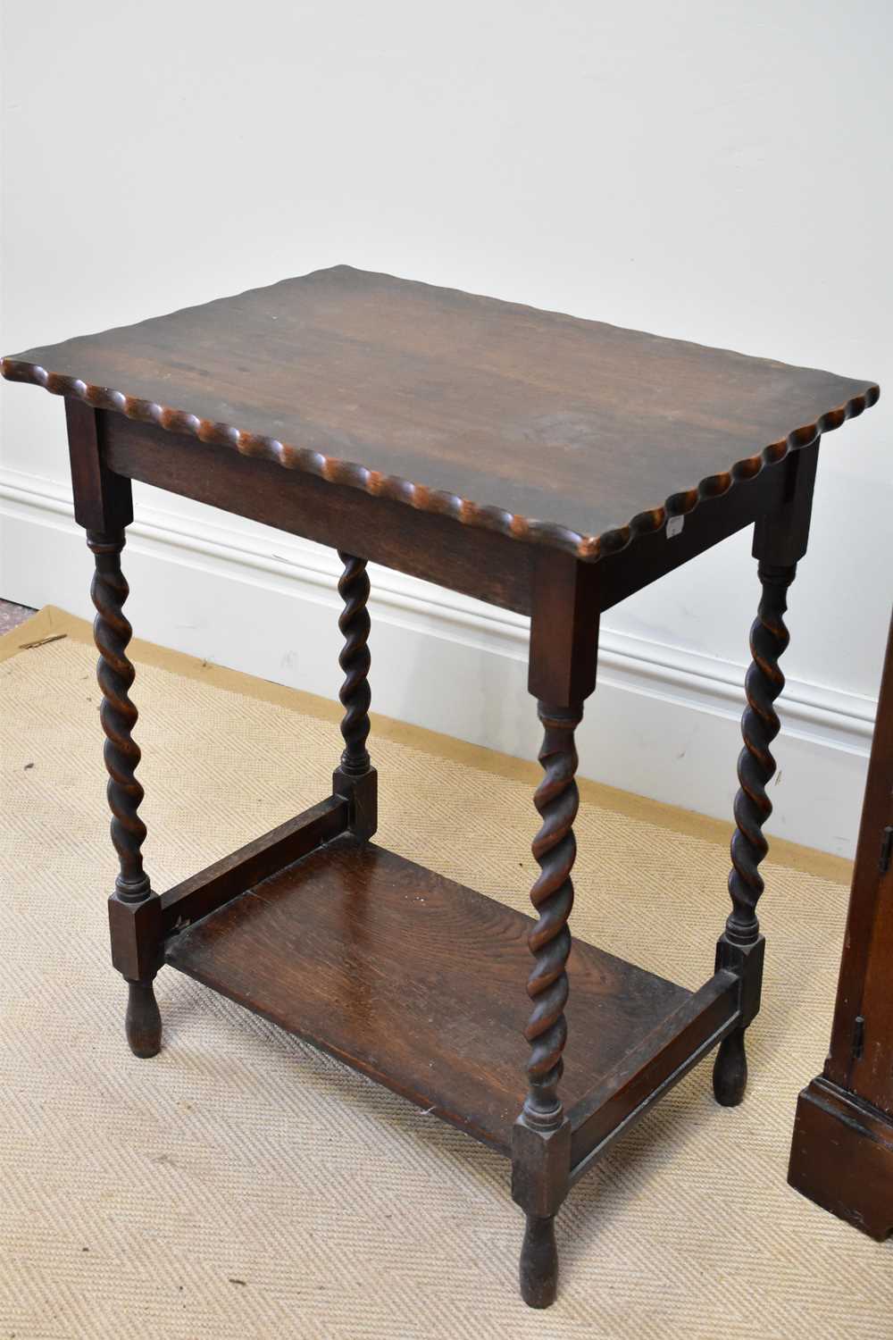 A reproduction oak freestanding bookcase with a fixed shelf above two panelled cupboard doors, width - Image 2 of 3