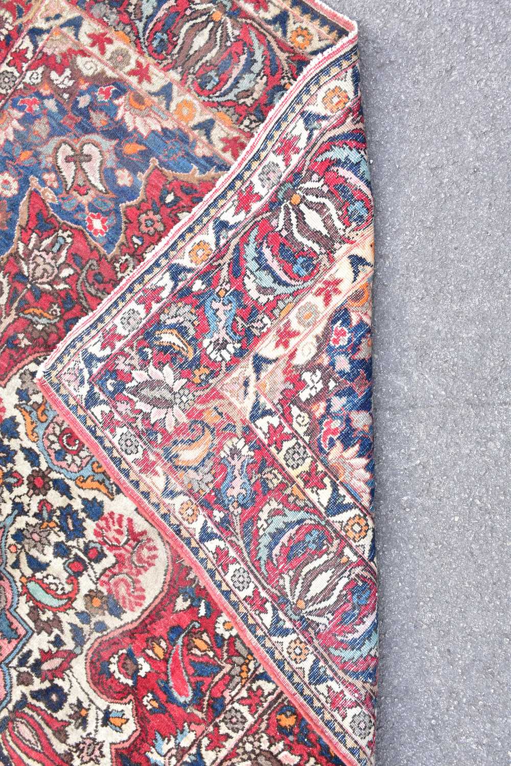 A red ground wool carpet with geometric central design, 224 x 140cm. - Image 2 of 3