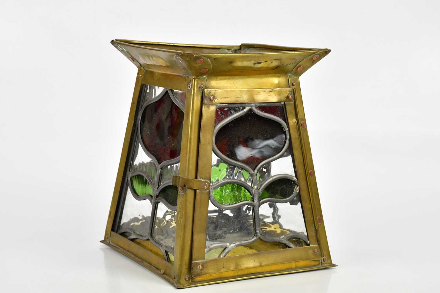 An Arts and Crafts style brass framed hanging lantern with leaded glass panels, height 23cm.