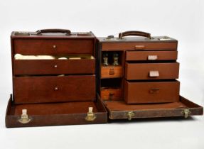 Two late 19th/early 20th century leather cased doctors' cases, the covers enclosing assorted drawers