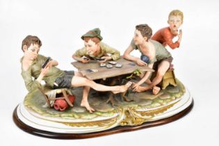 CAPODIMONTE; a large figure group, 'The Cheats', four boys playing cards, height 27cm. Condition