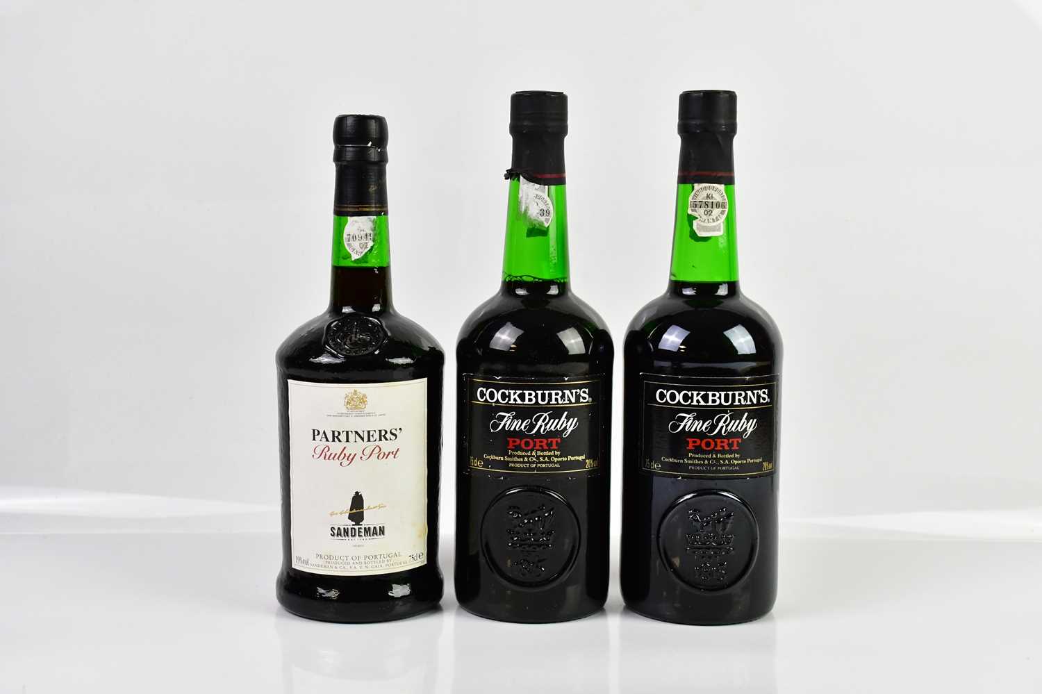 PORT; two bottles of Cockburn Fine Ruby port, 20%, 75cl, and a bottle of Partners' Ruby port, 19%,