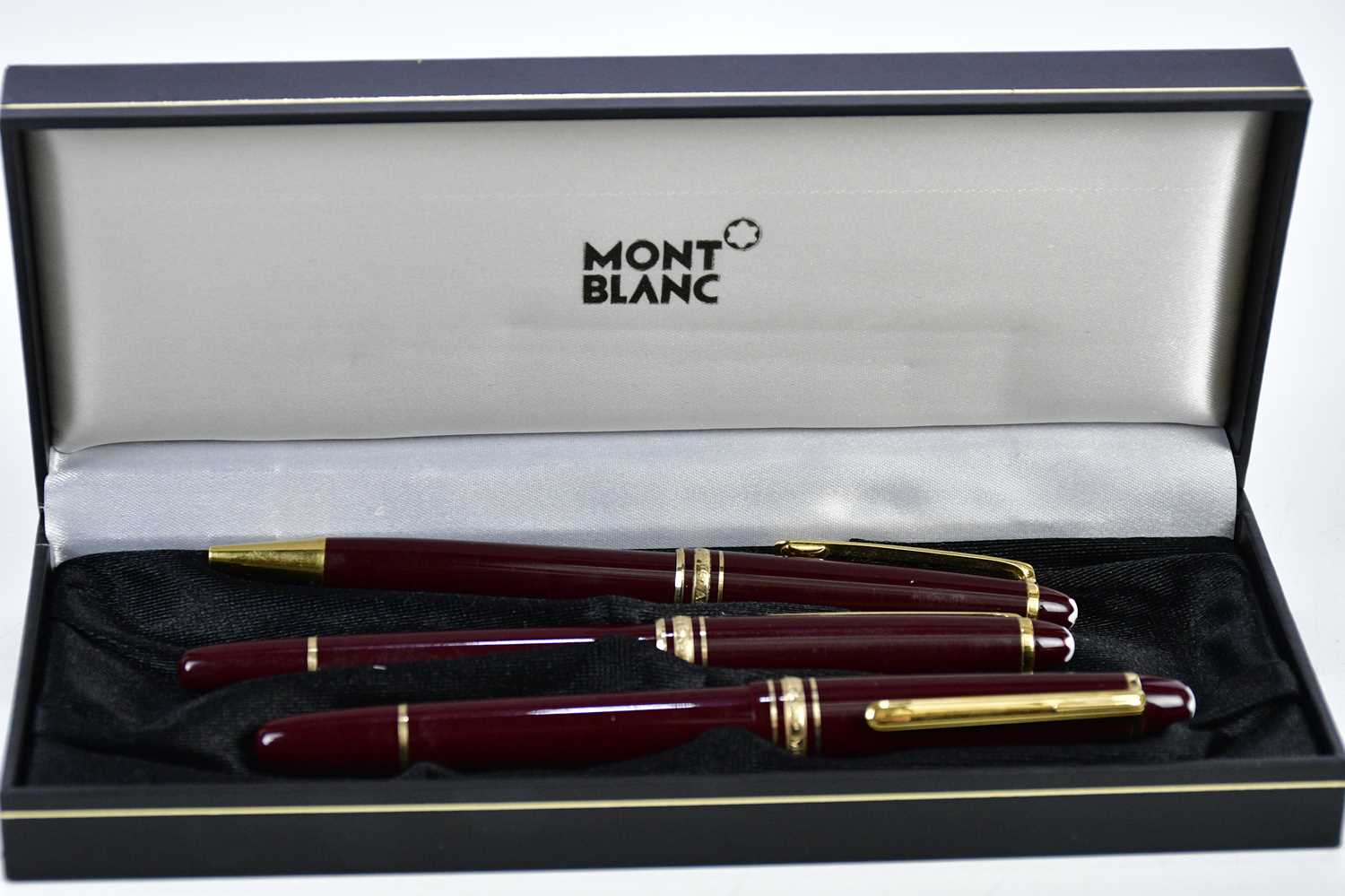 MONTBLANC; a set of three Meisterstuck burgundy pens including a cartridge fountain pen with 14K - Image 2 of 3