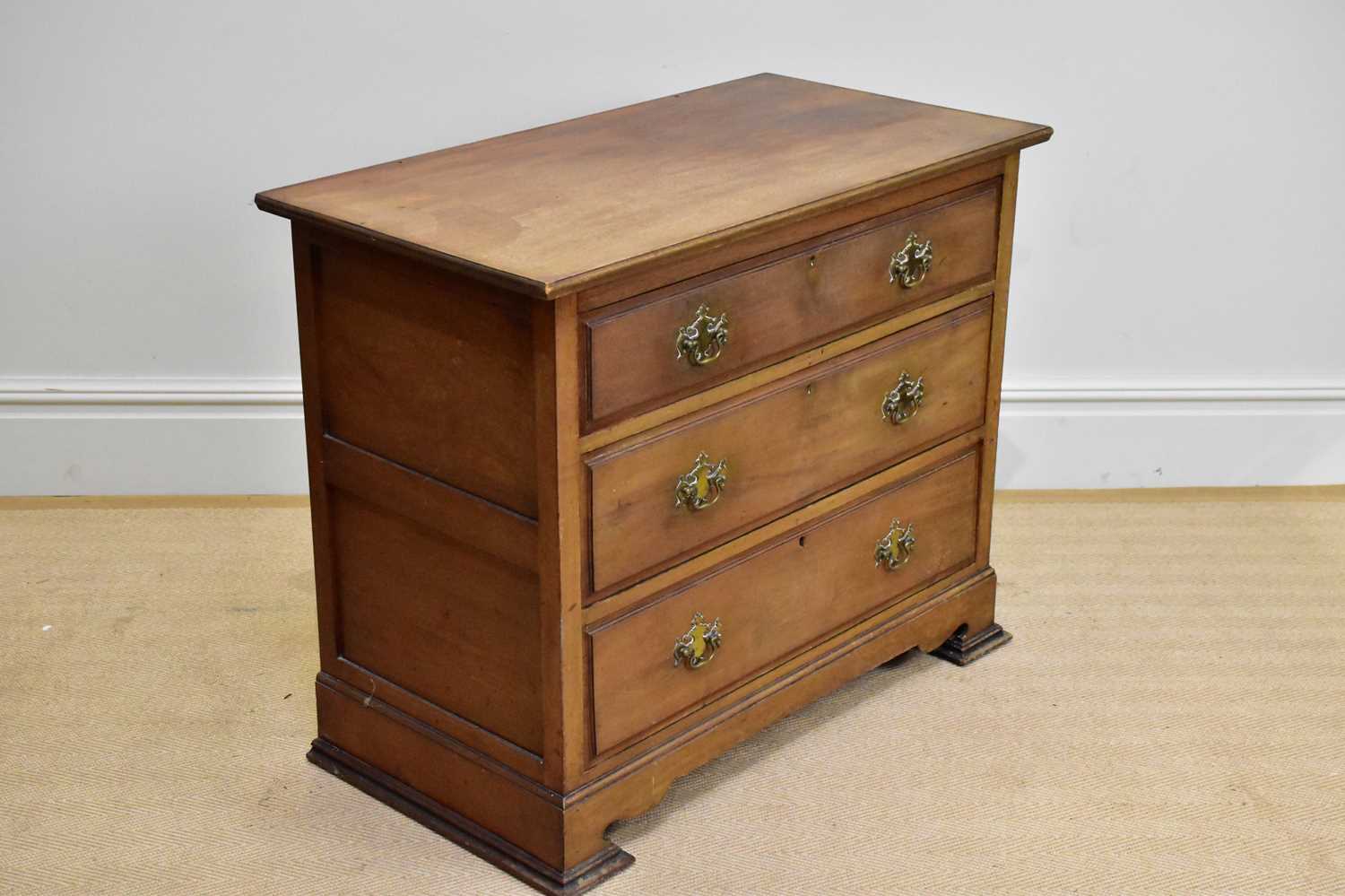 A late Victorian mahogany chest of three drawers on shaped bracket feet, width 98cm, depth 54cm,