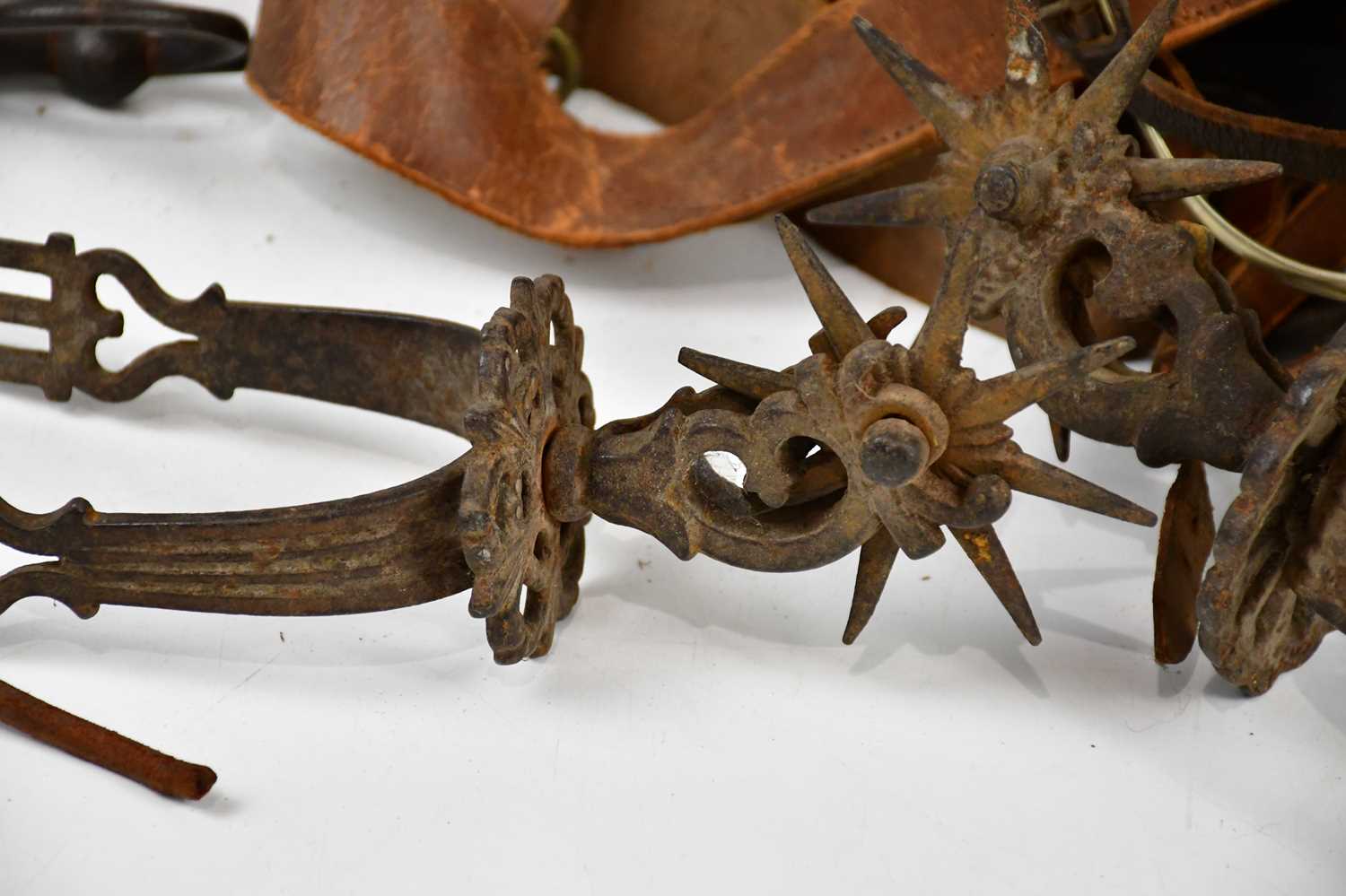 A pair of cast metal boot spurs and a collection of horse brasses. - Image 2 of 3