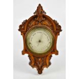 A late Victorian carved oak barometer, the silvered dial inscribed 'Newton & Co, Fleet Street,