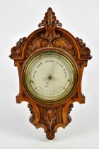 A late Victorian carved oak barometer, the silvered dial inscribed 'Newton & Co, Fleet Street,