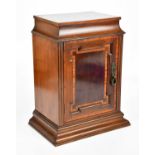 An Edwardian inlaid mahogany Sheraton Revival cabinet with single panelled door enclosing fixed