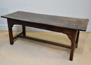 An 18th century style oak refectory type table, with single plank top, on square legs with H-