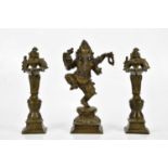 A bronze figure of Ganesh, together with a pair of bronze wick lamps, height of largest 29cm.