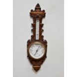 A late Victorian carved oak aneroid barometer, 88cm. Condition Report: Light general wear throughout