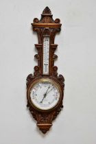 A late Victorian carved oak aneroid barometer, 88cm. Condition Report: Light general wear throughout