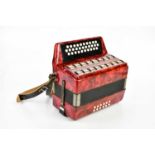 A thirty-one key red pearlescent melodeon, cased. Condition Report: All keys work, there is a