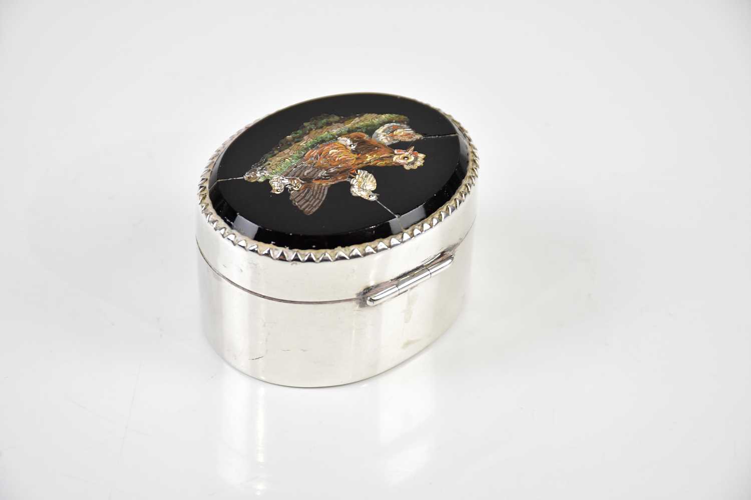 A Continental white metal pill box, the lid set with a micro-mosaic decorated depicting a hen and - Image 2 of 3