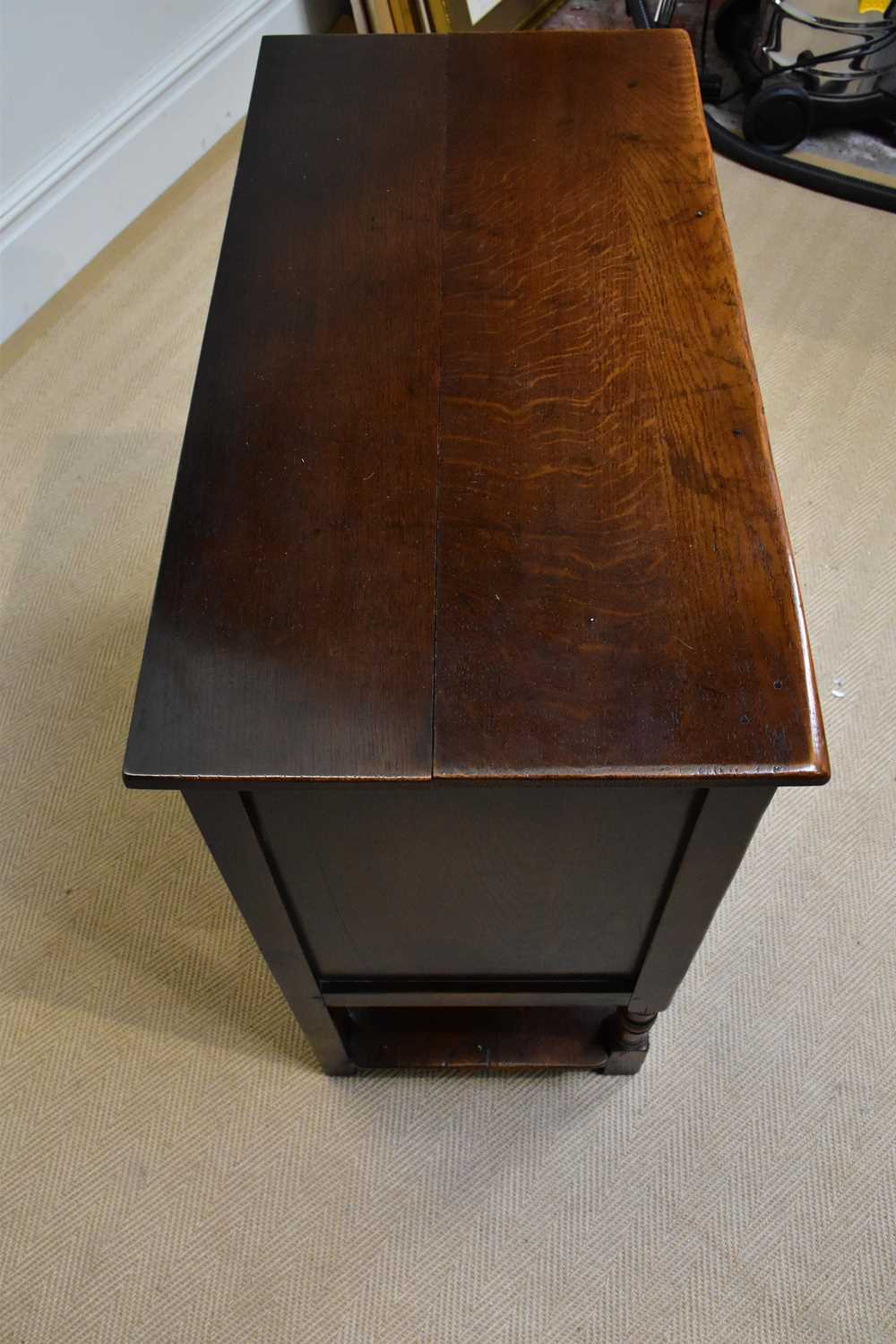 A reproduction oak side cabinet, with two panelled doors above single drawer and undertier, width - Image 3 of 3