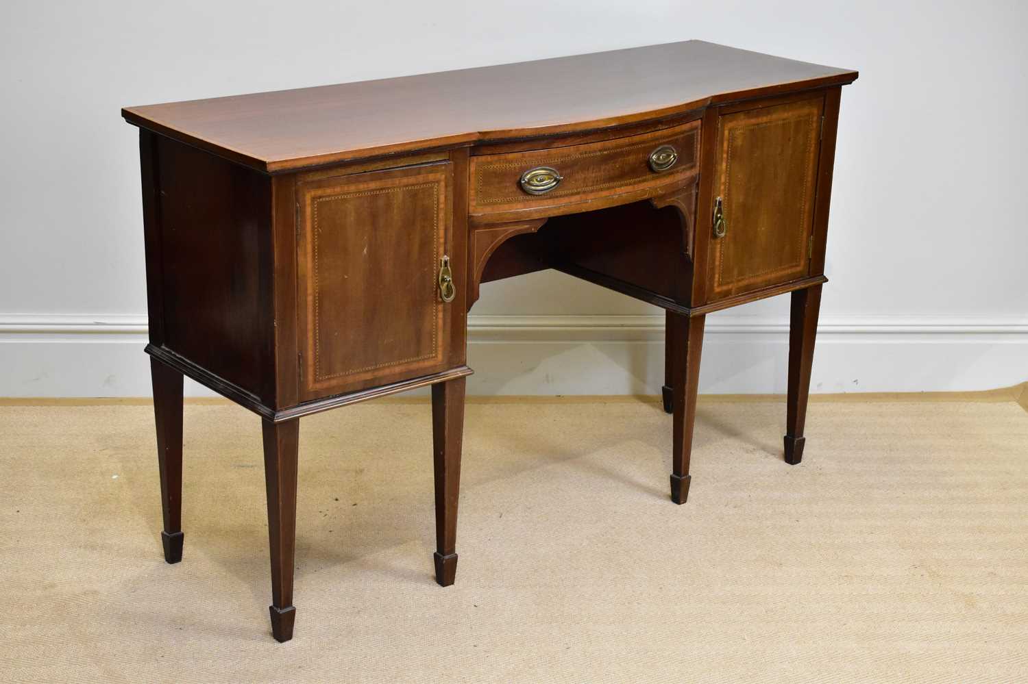 An Edwardian inlaid mahogany Sheraton Revival sideboard, with single drawer flanked by two