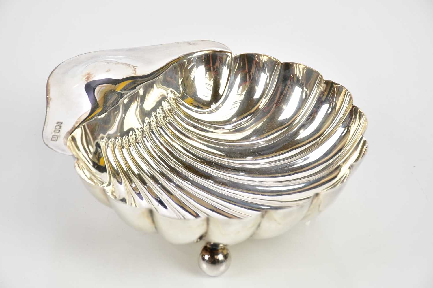 AITKEN BROS; a George V hallmarked silver shell shaped butter dish, Sheffield 1910, approx weight