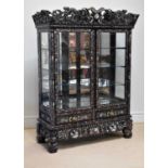 A Chinese ebonised carved display cabinet with mother of pearl inlaid decoration depicting