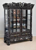 A Chinese ebonised carved display cabinet with mother of pearl inlaid decoration depicting