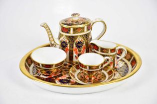 ROYAL CROWN DERBY; a miniature six piece tea service in the 1128 pattern. Condition Report: Each