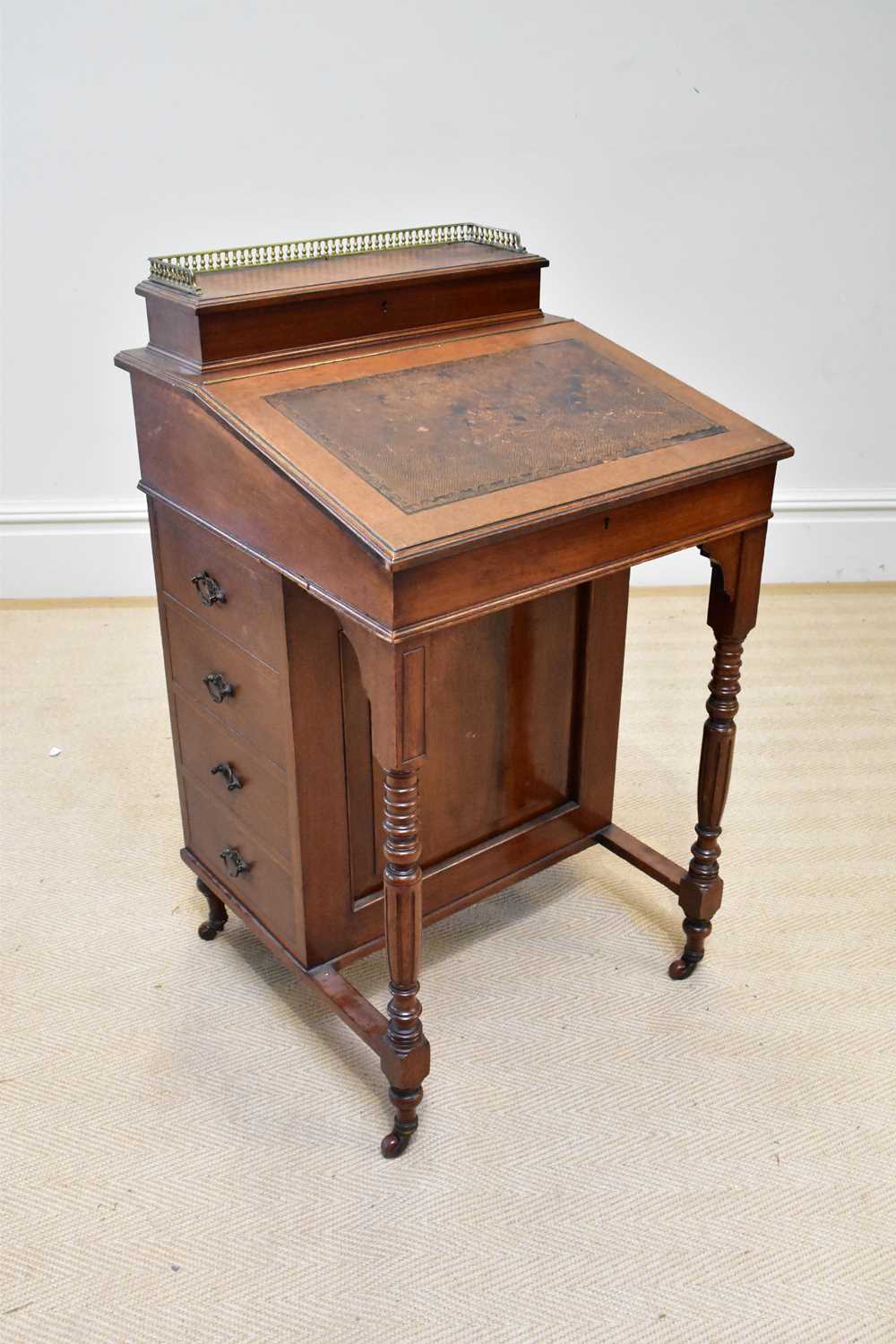 An Edwardian mahogany Davenport with four drawers to the right hand side and four faux drawers to