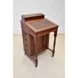 An Edwardian mahogany Davenport with four drawers to the right hand side and four faux drawers to