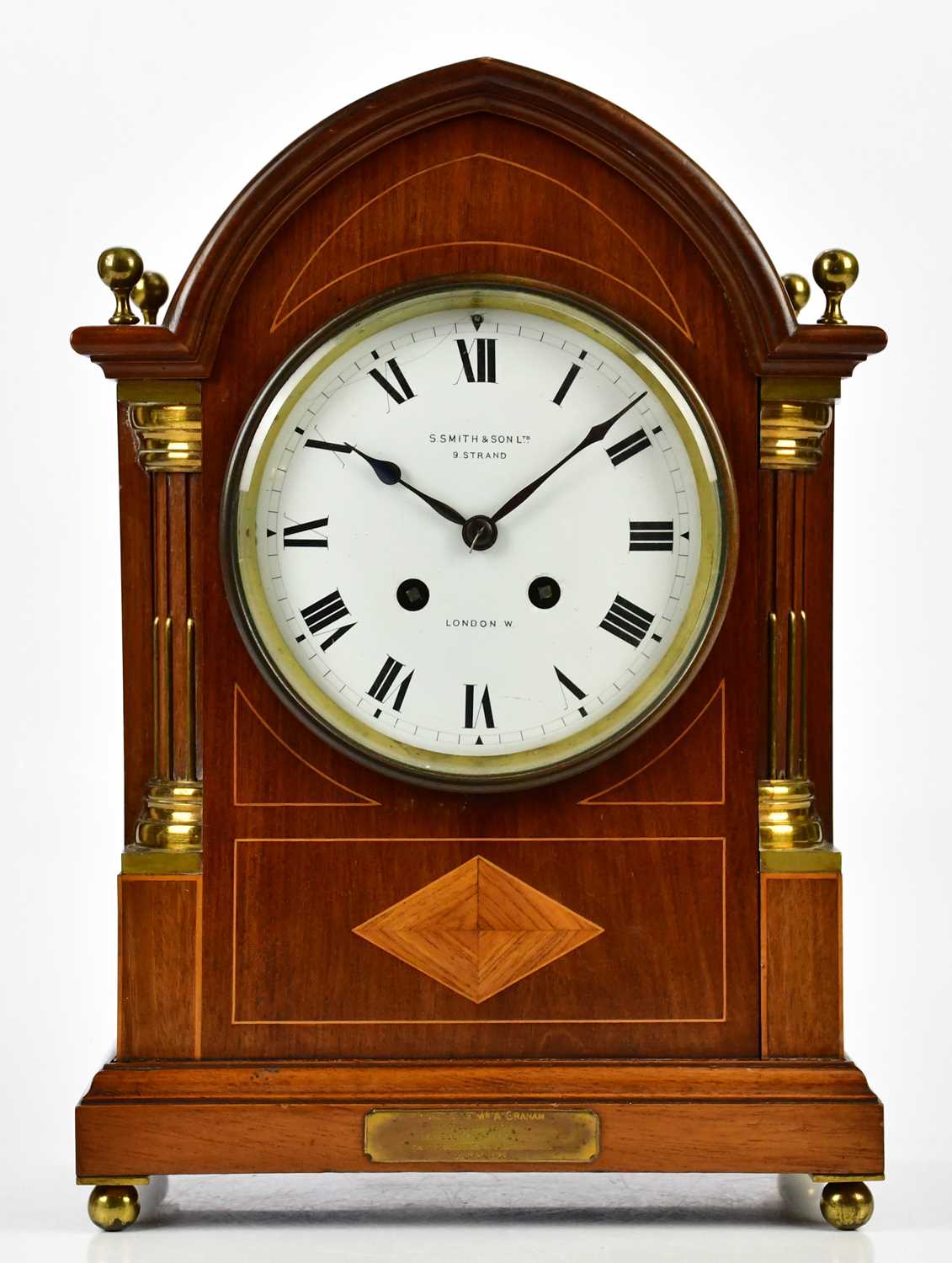 S SMITH & SONS LTD, LONDON; an Edwardian inlaid mahogany arch topped mantel clock with four brass