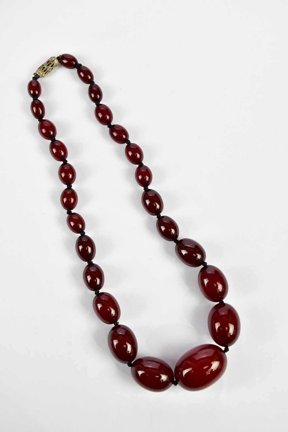 A cherry amber beaded necklace, length 43cm, approximate weight 44.4g. Condition Report: As