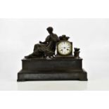 A Victorian figural mantel clock representing a bronzed figure of Grecian male beside the drum faced