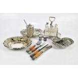 A small quantity of plated items including a condiment stand, fish servers and carving set with