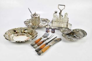 A small quantity of plated items including a condiment stand, fish servers and carving set with