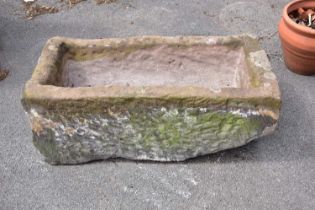 A sandstone trough, height 33cm, width 90cm, depth 45cm.