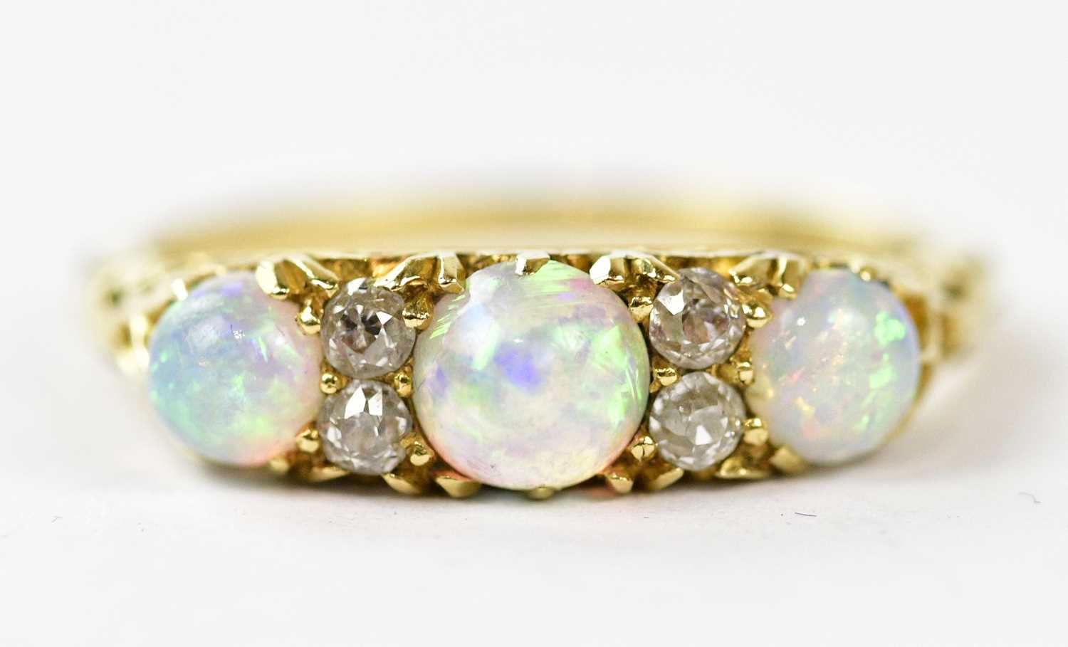 A Victorian yellow metal opal and diamond set dress ring, size J, approx weight 3g.