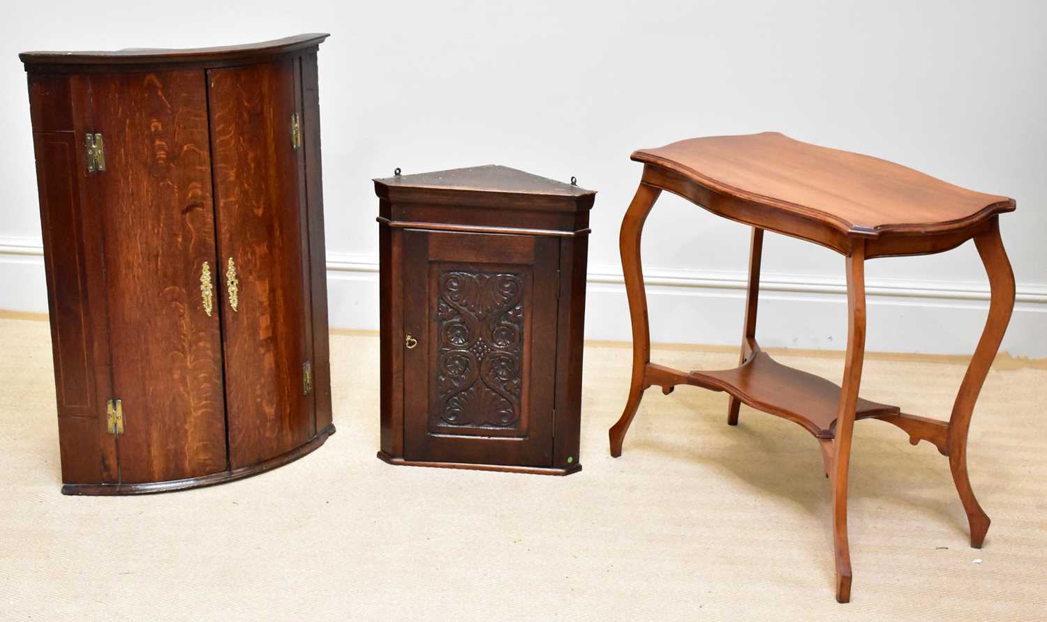 A Georgian oak corner cupboard, height 95cm, width 67cm, depth 46cm,and a similar smaller example