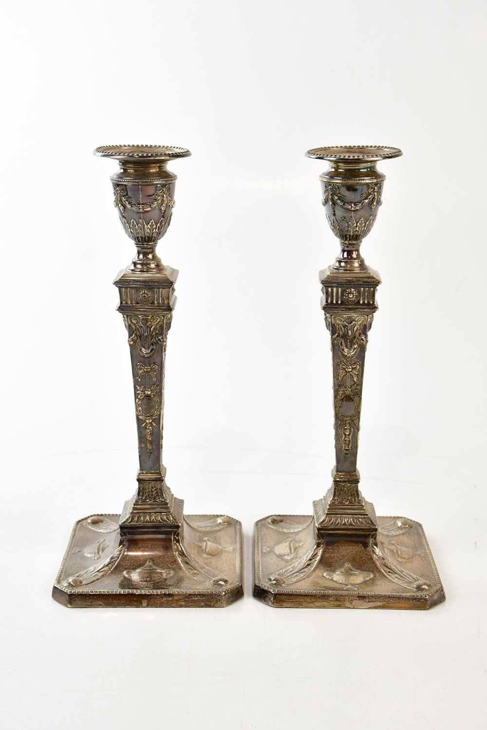 MARTIN, HALL & CO; a pair of Victorian hallmarked silver weighted candlesticks, London 1891,