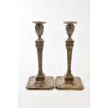 MARTIN, HALL & CO; a pair of Victorian hallmarked silver weighted candlesticks, London 1891,