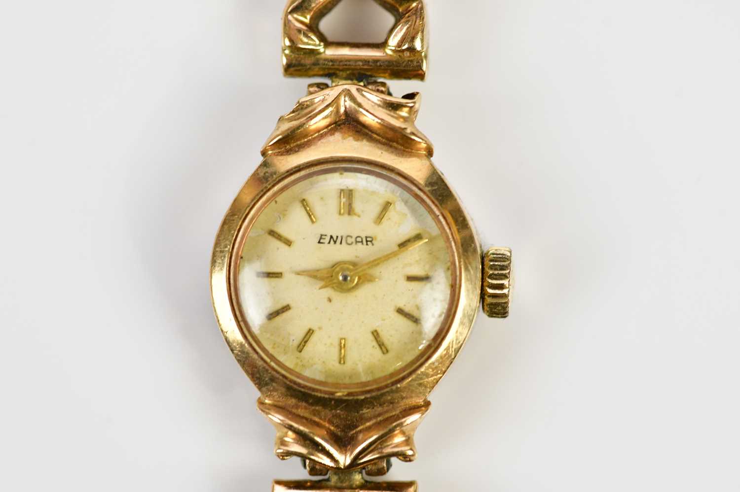 ENIGAR; a 9ct gold lady's wristwatch, set with batons, on 9ct gold textured strap, total weight