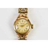 ENIGAR; a 9ct gold lady's wristwatch, set with batons, on 9ct gold textured strap, total weight