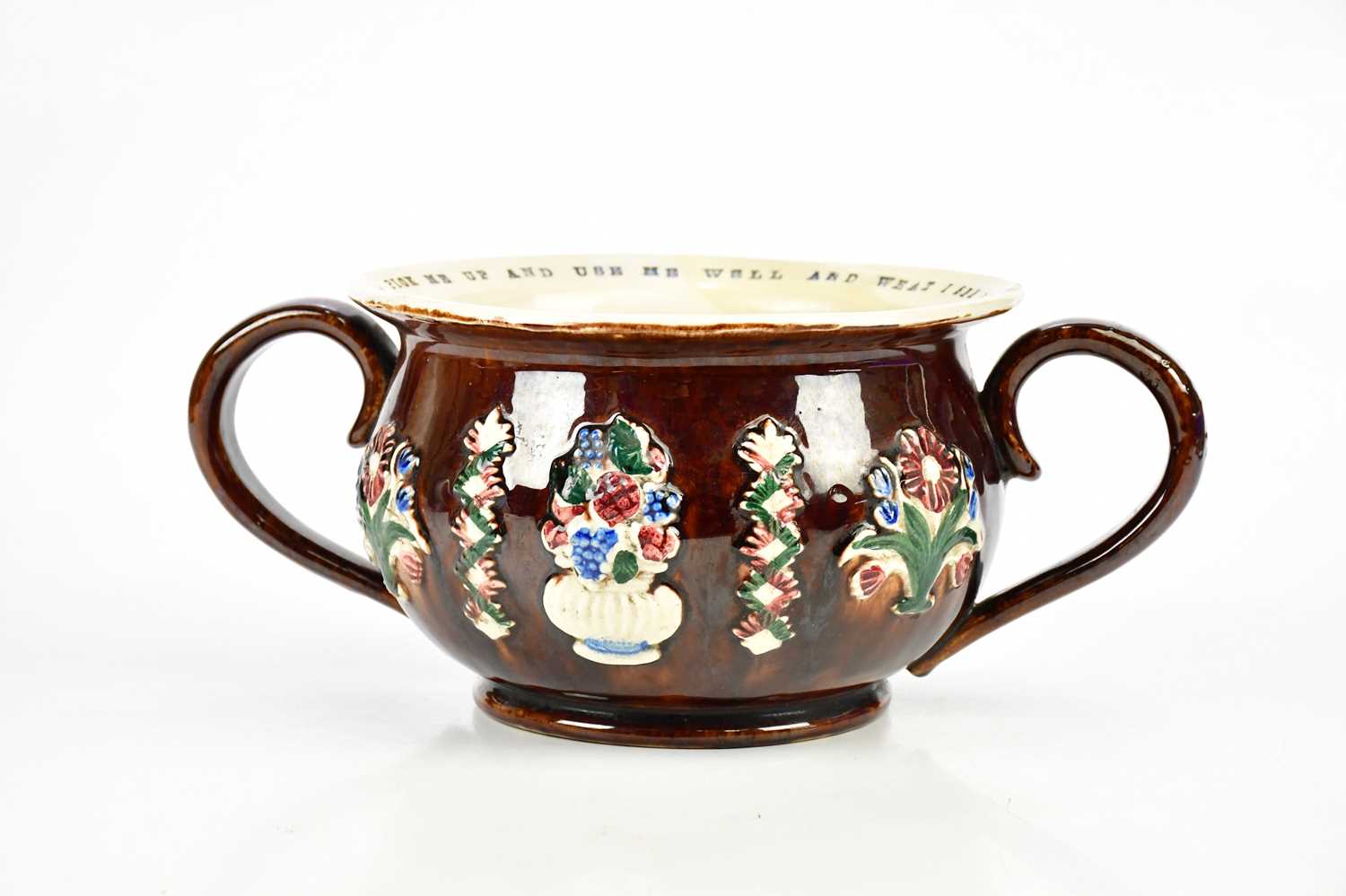 BARGEWARE; a chamber pot, inscribed 'Pick me up, use me well and what I see I will not tell, Jonas