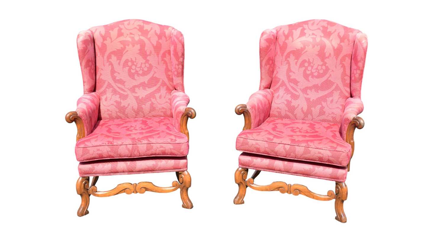 A pair of reproduction upholstered wingback armchairs.