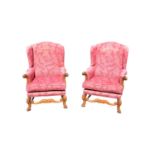 A pair of reproduction upholstered wingback armchairs.