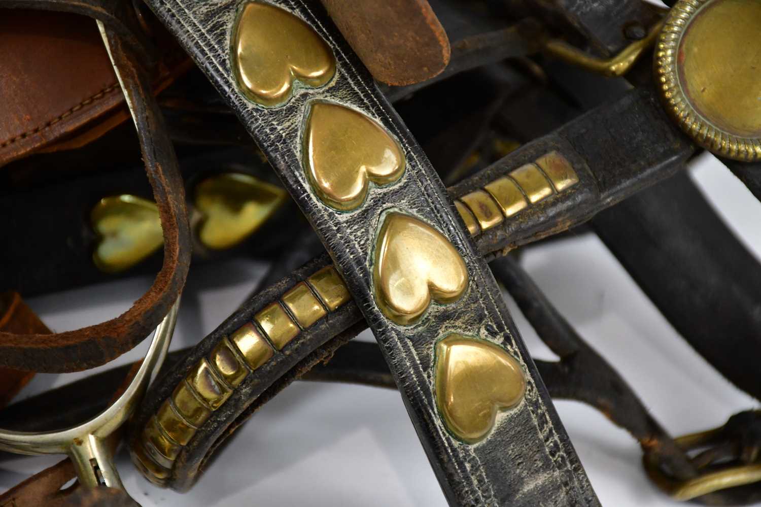 A pair of cast metal boot spurs and a collection of horse brasses. - Image 3 of 3