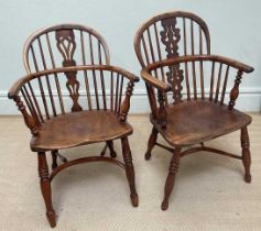 A near pair of 19th century elm and yew wood Windsor elbow chairs, with crinoline stretchers.