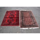 A Bokhara hand woven wool rug, with three gulls against a red ground, 147 x 103cm, and a similar