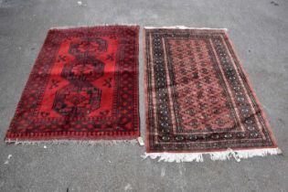 A Bokhara hand woven wool rug, with three gulls against a red ground, 147 x 103cm, and a similar