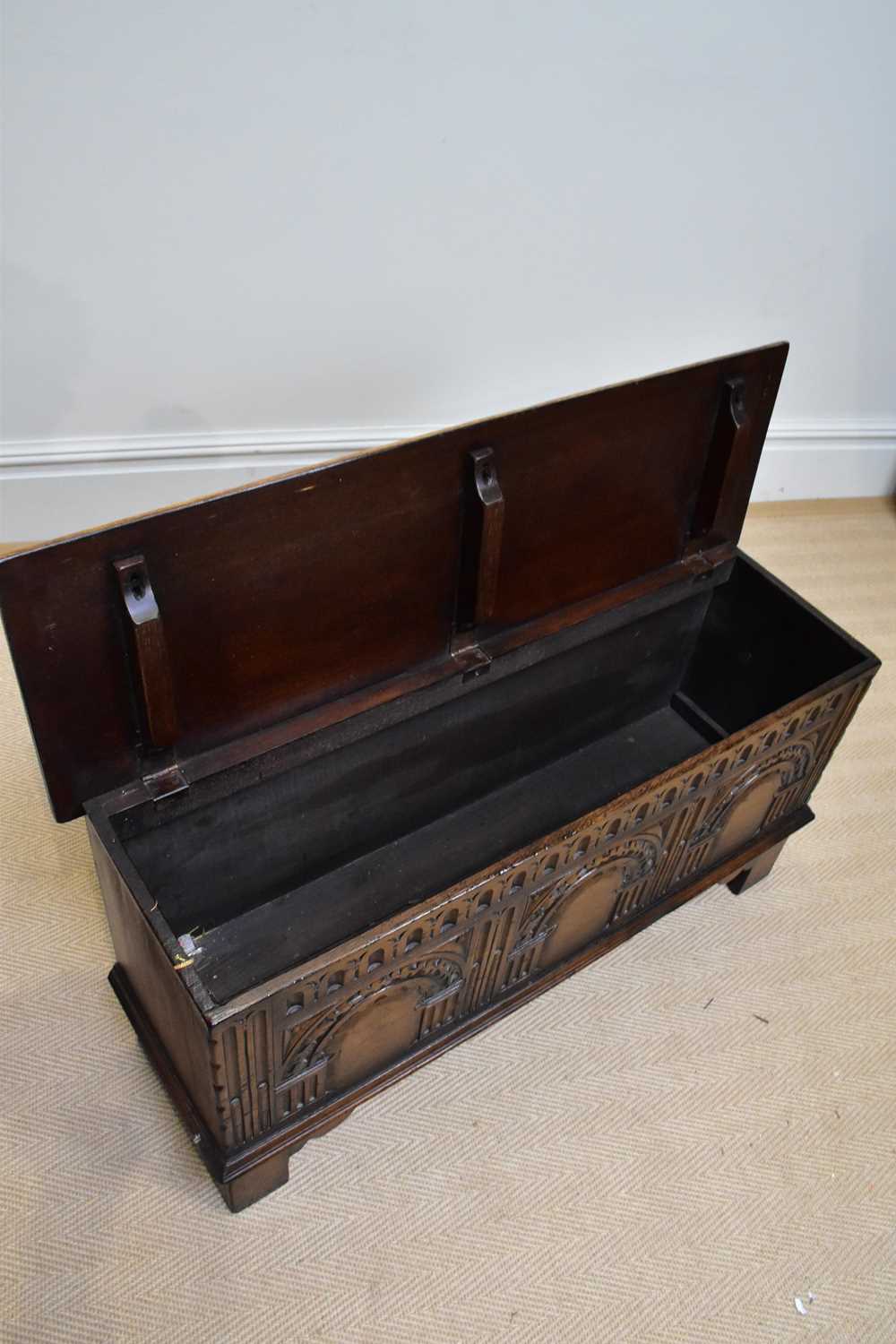 A reproduction oak blanket chest with carved and panelled front, on block legs, width 99cm, depth - Image 2 of 2